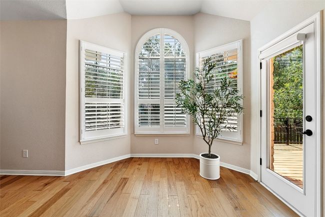 The wood-shuttered bay window adds character and charm, creating a cozy nook perfect for enjoying morning coffee or reading while taking in the peaceful views outside | Image 20