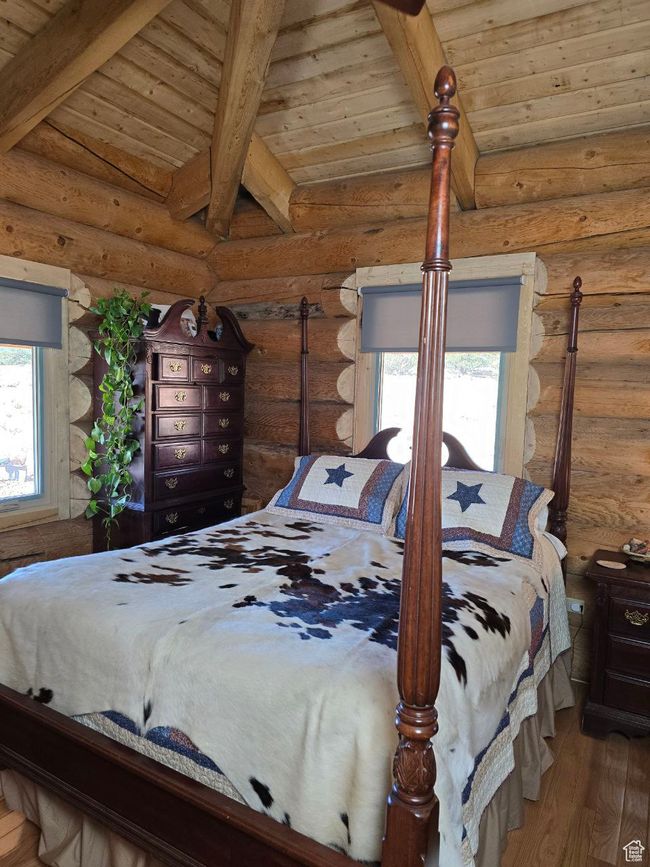 Bedroom featuring wooden ceiling, lofted ceiling with beams, and wood finished floors | Image 89