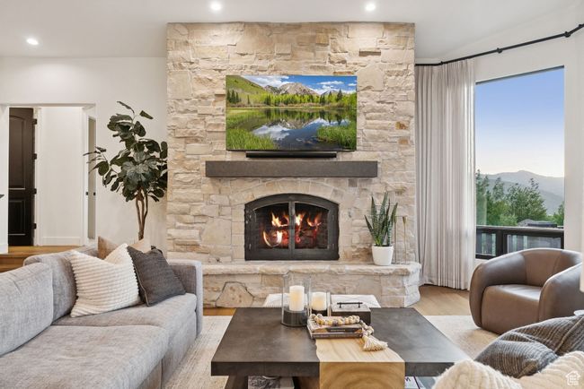 Living area featuring wood finished floors, a fireplace, and recessed lighting | Image 20
