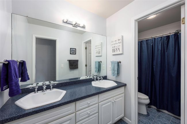 Carpeted bedroom with ceiling fan and baseboard heating | Image 28
