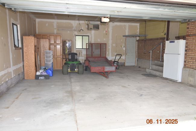 Garage with freestanding refrigerator and a garage door opener | Image 27