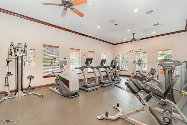 Workout area with ceiling fan, baseboards, crown molding, and recessed lighting | Image 25