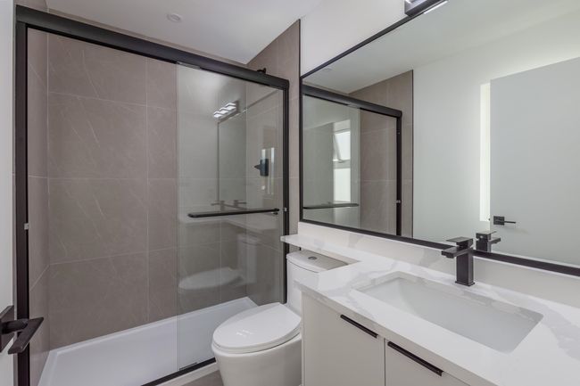 Full bathroom featuring vanity, a shower stall, and toilet | Image 24