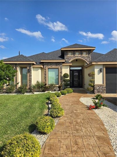 Prairie-style home featuring a garage and a front lawn | Image 1