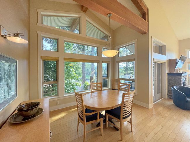 Dining space with high vaulted ceiling, light wood finished floors, plenty of natural light, and beamed ceiling | Image 14
