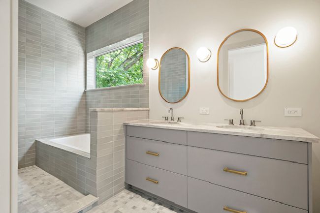Full bath featuring double vanity, tile walls, tiled bath, and tile patterned flooring | Image 15