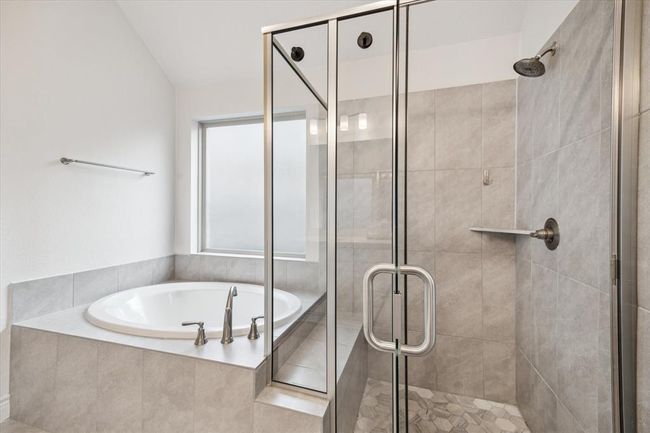 Step into a spa-like sanctuary where a generous soaking tub invites deep relaxation, while the separate oversized shower provides a refreshing escape, together creating the perfect balance of indulgence and tranquility. | Image 20