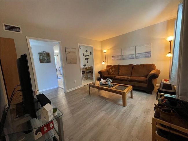 Bedroom with light wood-style floors and a ceiling fan | Image 7