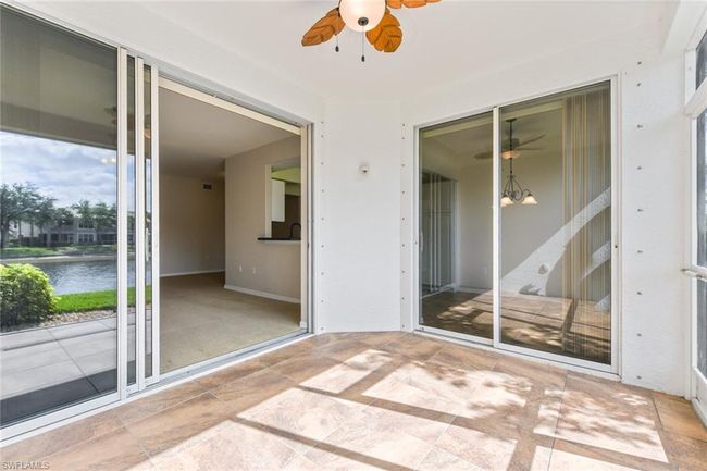 Unfurnished sunroom featuring a water view and ceiling fan | Image 31