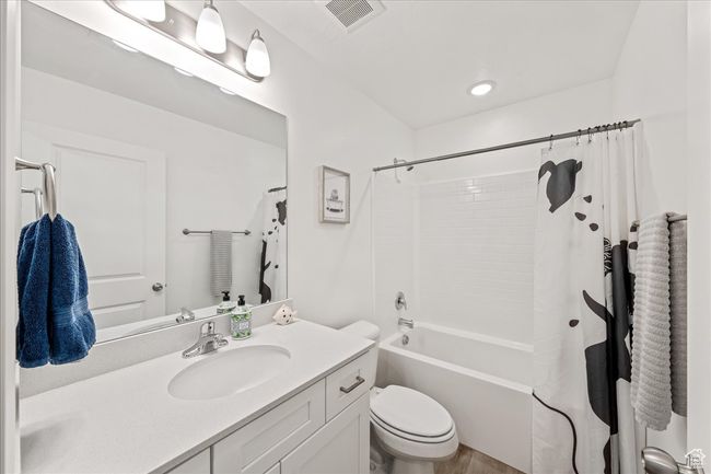 Bathroom featuring vanity and shower / bath combo with shower curtain | Image 27