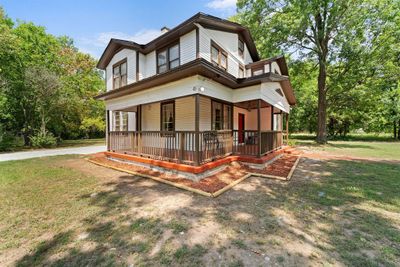 View of property exterior with a porch and a yard | Image 3