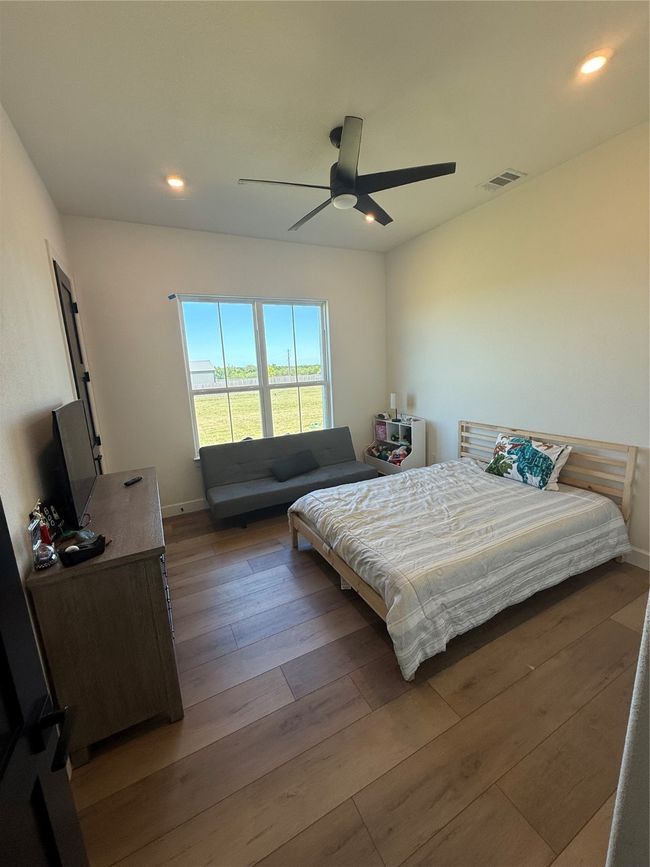 Bedroom featuring recessed lighting, wood finished floors, and a ceiling fan | Image 5