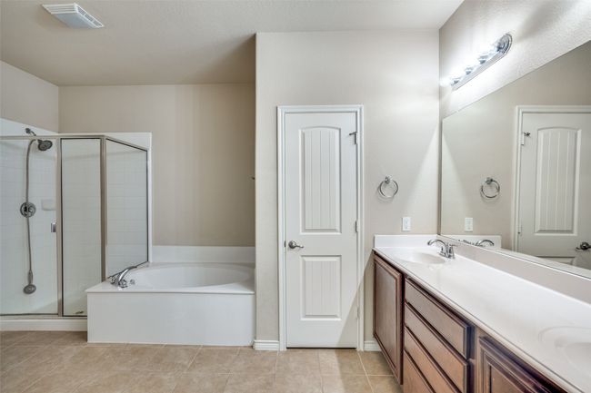 Full bath with a garden bathtub, a sink, double vanity, linen closet, and a separate shower | Image 19