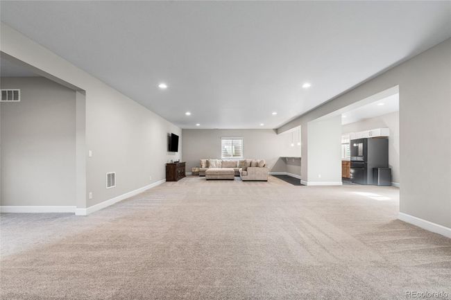 Full-size finished basement with 2nd kitchen area/wetbar complete with Samsung BeSpoke fridge and dishwasher, quartz countertops and plenty of cabinet storage. | Image 34