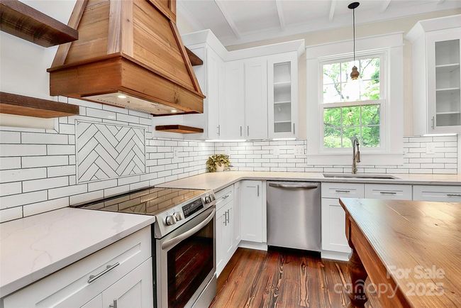 Quartz countertops and ceramic coated brick compliment this elegant kitchen | Image 18