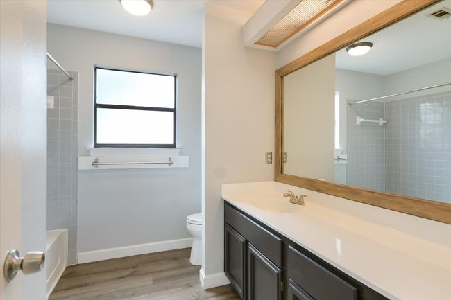 The main level full bath is well-appointed for guests and the two secondary bedrooms. | Image 14