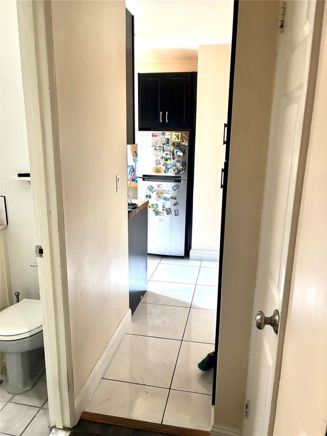 Corridor with light tile patterned flooring and baseboards | Image 13