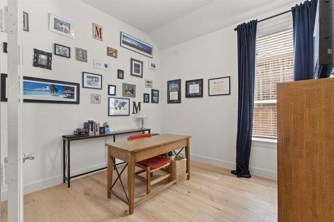 Office area featuring vaulted ceiling, light wood-style flooring, and plenty of natural light | Image 19