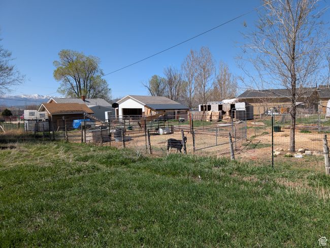 View of yard with fence and an outdoor structure | Image 7
