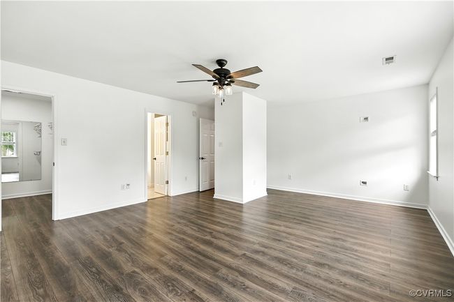 Another view of Primary bedoom with a ceiling fan and Laminate Style floors | Image 17