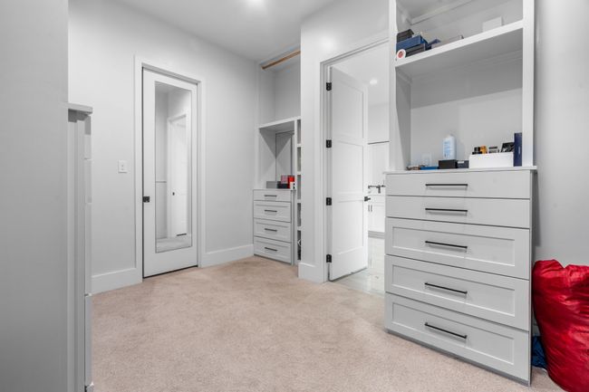 Spacious closet featuring light colored carpet | Image 14