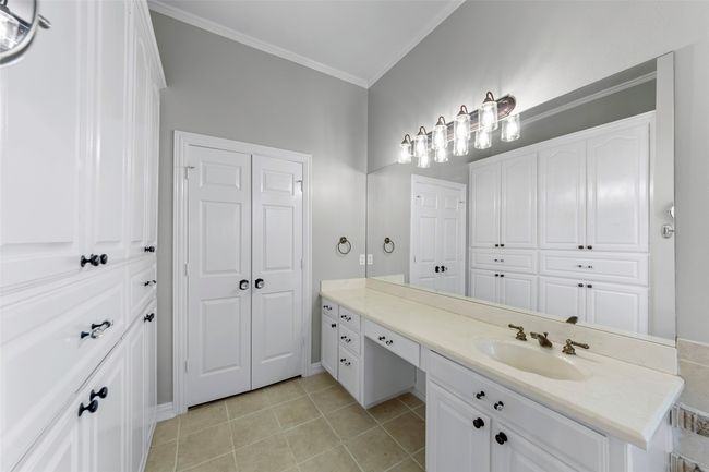 PRIMARY BATHROOM...Tile Floor, 2 Separate Vanities, Dressing Table, B/I Linen Cabinet, Large W/I Closet | Image 26