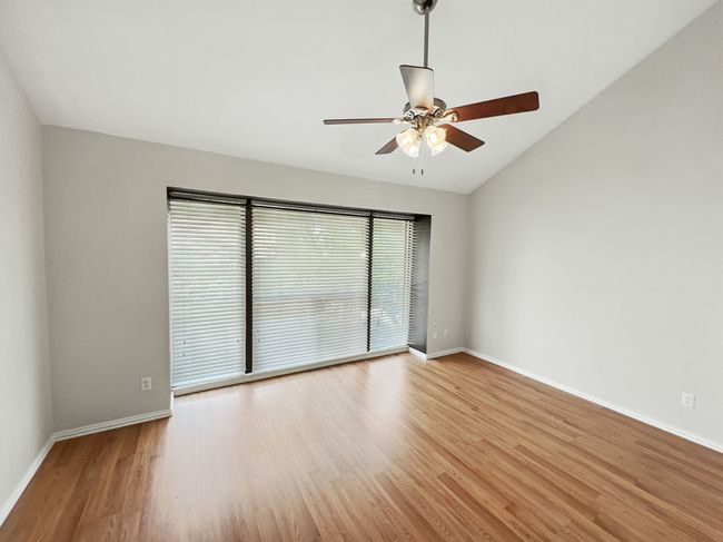 Bedroom room with lofted ceiling, light wood finished floors, and ceiling fan | Image 14
