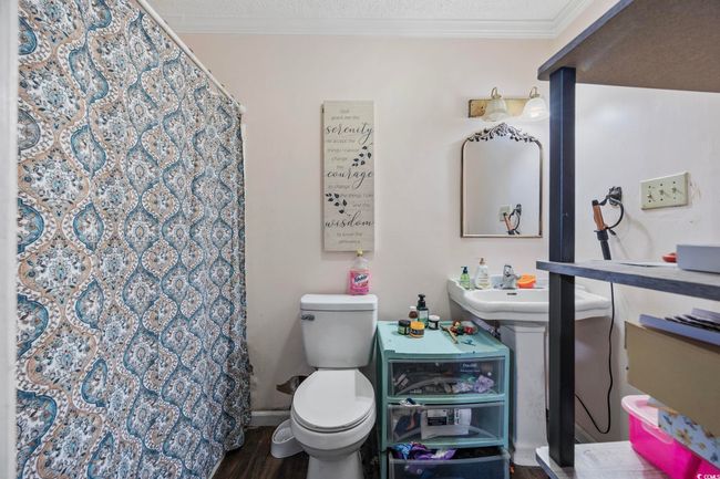 Full bath with ornamental molding, a shower with curtain, and wood finished floors | Image 14