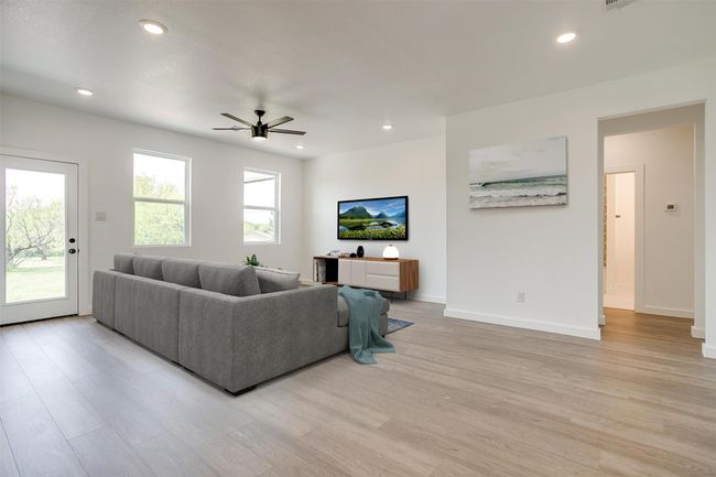 Living area with baseboards, recessed lighting, light wood-style flooring, and ceiling fan | Image 7