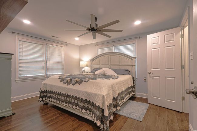 Bedroom with wood finished floors, a ceiling fan, and recessed lighting | Image 10