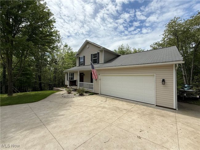 View of front of house with a porch, driveway, and an attached garage | Image 46