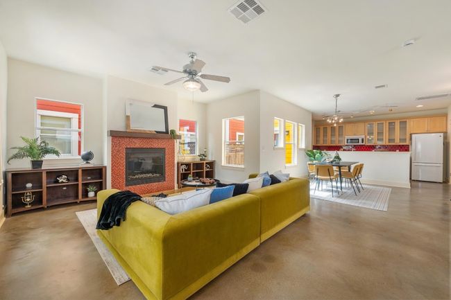 Windows wrap around the living room, flooding the space with natural light and creating a connection to the outdoors, making it feel expansive and alive with possibility | Image 4