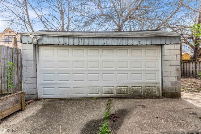 Detached garage featuring fence | Image 26