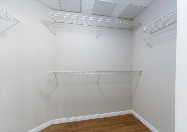 Walk in closet with wood finished floors | Image 19
