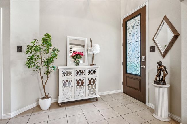Entrance foyer featuring light tile patterned floors and baseboards | Image 5