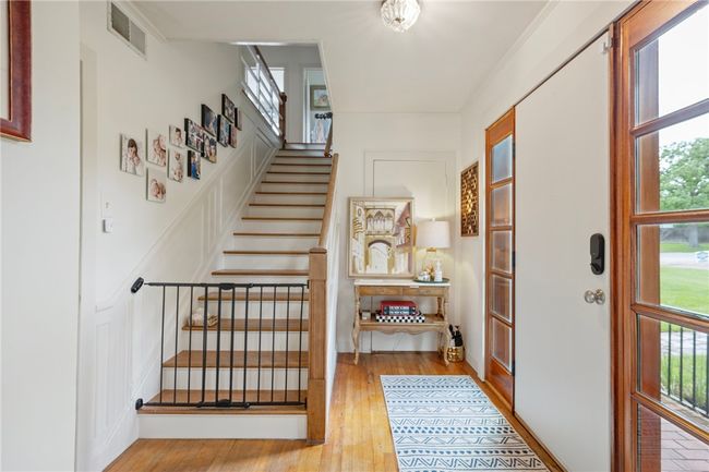 Staircase featuring plenty of natural light and wood finished floors | Image 7