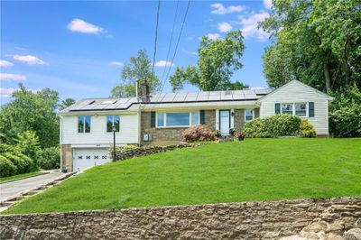 Ranch-style home with solar panels. | Image 2