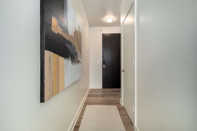 Discover the newly installed, wide-plank European white oak flooring—a premium upgrade not commonly found in other units. The warm, modern tones add a sophisticated touch to the home's contemporary design. | Image 5