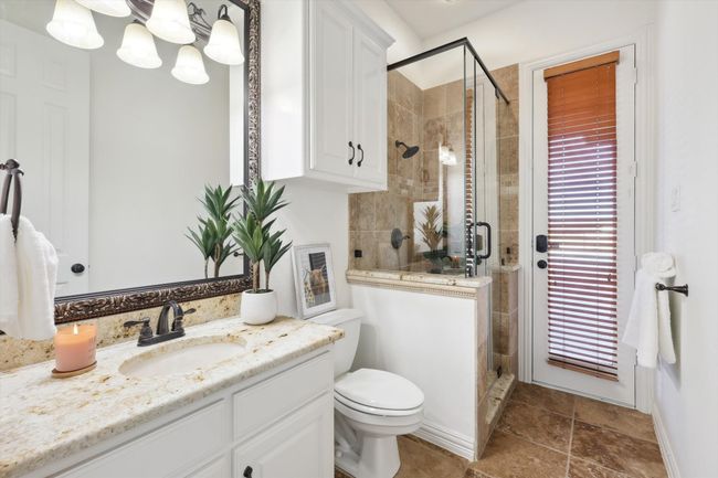 Bathroom featuring vanity, a stall shower, and toilet with pool access | Image 21