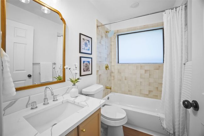 Full bathroom featuring vanity and shower / bathtub combination with curtain | Image 19