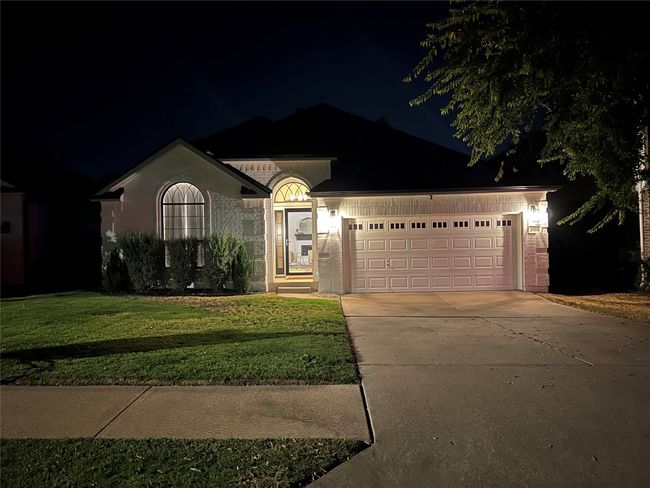 Single story home featuring driveway, a garage, a yard, and brick siding | Image 30