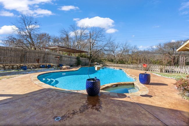 View of swimming pool with an in ground hot tub and a patio | Image 32
