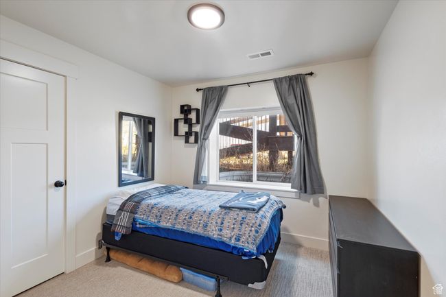 Carpeted bedroom featuring baseboards and visible vents | Image 31