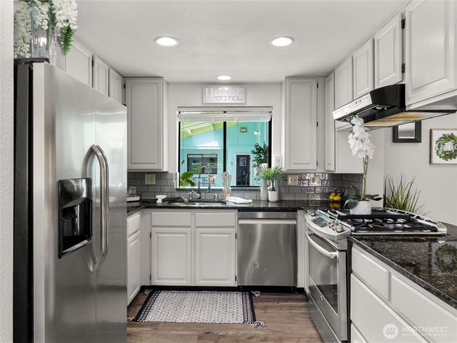 Kitchen features stainless appliances. | Image 13