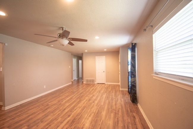 Spare room featuring light wood-style flooring, a ceiling fan, recessed lighting, and baseboards | Image 4