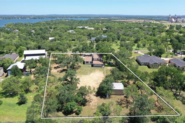 Aerial view of property's location with property boundaries highlighted and a large body of water | Image 30