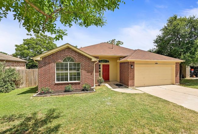 Single story home with a garage, brick siding, driveway, and a shingled roof | Image 6