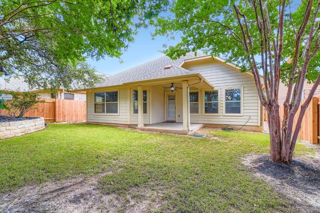 View of the back of the house with a patio area, a fenced backyard, a ceiling fan, and roof with shingles | Image 28