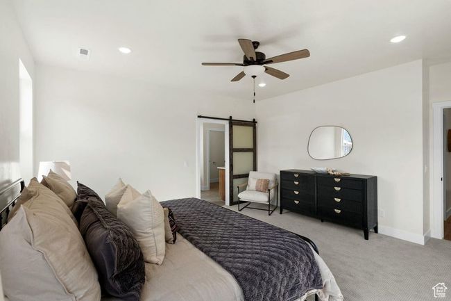 Bedroom featuring a barn door, recessed lighting, carpet, baseboards, and ceiling fan | Image 24