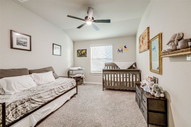 Bedroom with vaulted ceiling, carpet flooring, ceiling fan, and baseboards | Image 29